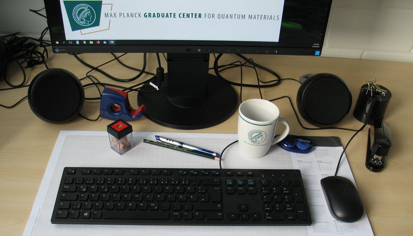 Work table with keyboard, screen and other office utensils.